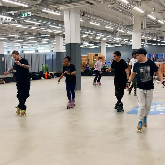 Group of skaters practicing backwards roller skating at Mellow Moves Roller skate Flow lesson in Decathlon Surrey Quays