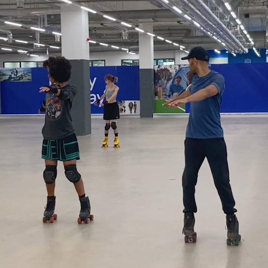 Group of skaters practicing backwards roller skating at Mellow Moves Roller skate Foundations lesson in Decathlon Surrey Quays.